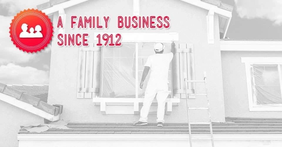 A painter cutting in around a window on a house exterior, over the words A Family Business Since 1912